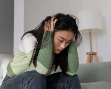 anxious-worried-asian-millennial-girl-holding-head-2023-11-27-05-27-29-utc (1)